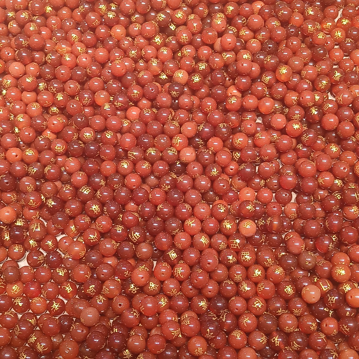 Red agate beads. Photo by François Nguyen, CC BY 2.0 via Wikimedia Commons.
