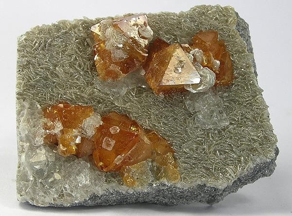 Scheelite crystals from Xuebaoding Mountain, Sichuan, China. Photo by Robert M. Lavinsky / iRocks.com, CC BY-SA 3.0 via Wikimedia Commons.