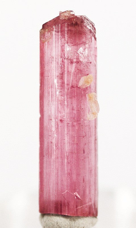 Vivid cranberry-red Rubellite tourmaline crystal from the Jonas Mine, Minas Gerais, Brazil. Photo by Robert M. Lavinsky / iRocks.com, CC BY-SA 3.0 via Wikimedia Commons.