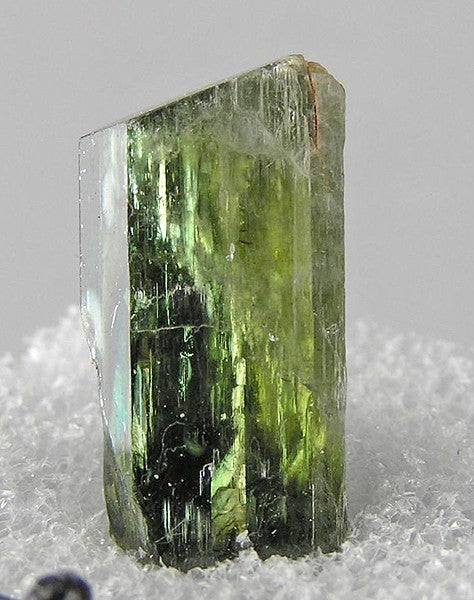 Tremolite crystal specimen, identified by RRUFF. Photo by Robert M. Lavinsky / iRocks.com, CC BY-SA 3.0 via Wikimedia Commons.