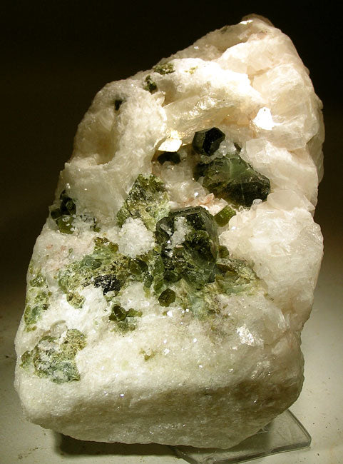 Uvite tourmaline crystals on magnesite from Brumado, Bahia, Brazil. Photo by Robert M. Lavinsky / iRocks.com, CC BY-SA 3.0 via Wikimedia Commons.