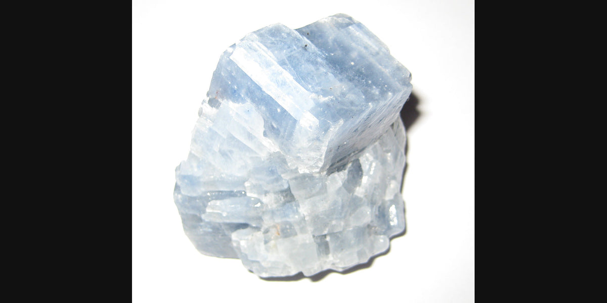 Blue calcite specimen; photo by Stephanie Clifford, CC BY 2.0 — Roosters Peacock crystal guide