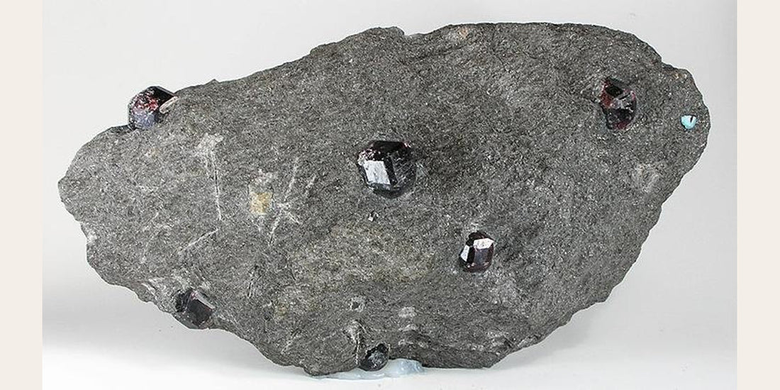 Representative almandine garnet specimen; photo by Robert M. Lavinsky, CC BY-SA 3.0 — Roosters Peacock crystal guide