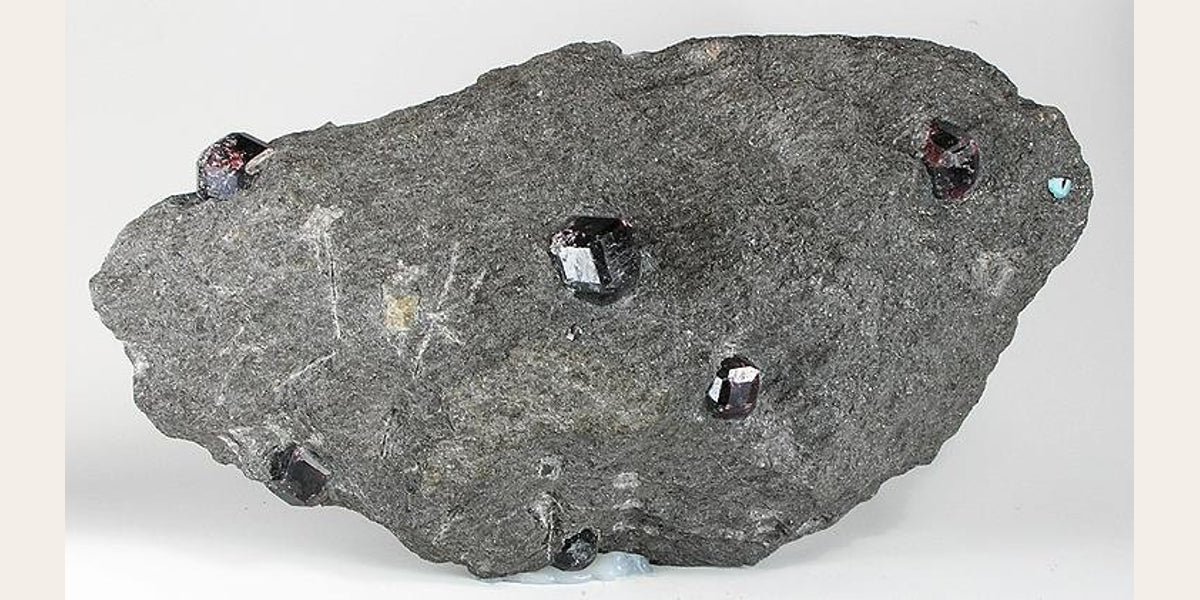 Representative almandine garnet specimen; photo by Robert M. Lavinsky, CC BY-SA 3.0 — Roosters Peacock crystal guide