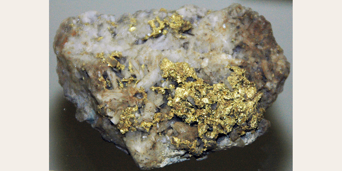 Native gold on quartz from California; photo by James St. John, CC BY 2.0 — Roosters Peacock crystal guide