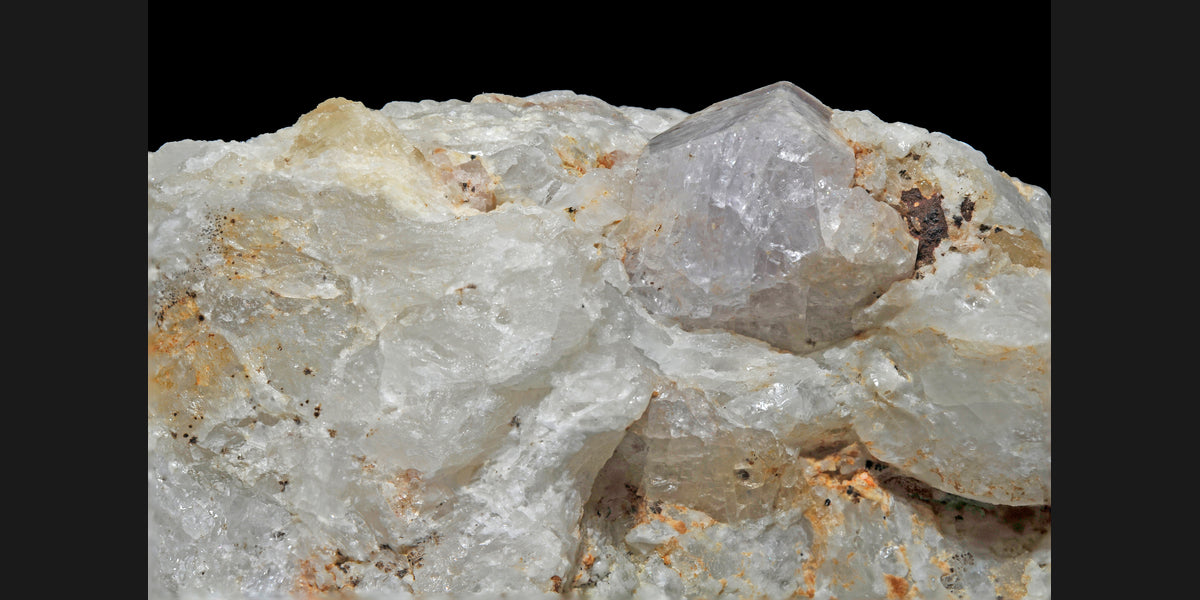 Hackmanite crystals from Afghanistan; photo by Géry Parent, CC BY-SA 3.0 — Roosters Peacock crystal guide