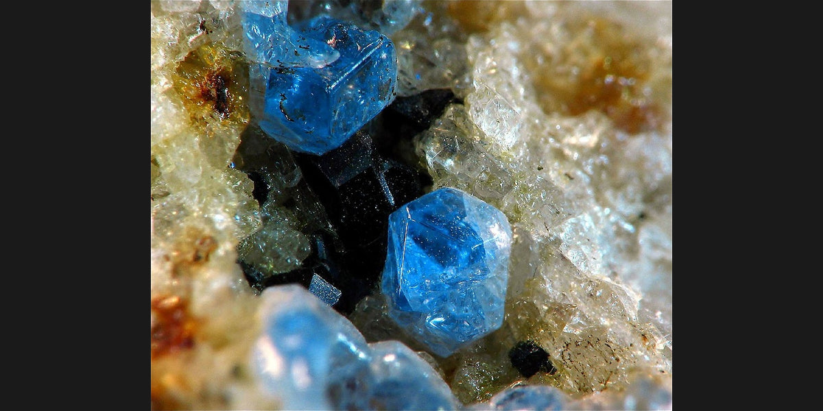 Haüyne specimen from Germany; photo by Lucien Cluzaud, public domain — Roosters Peacock crystal guide