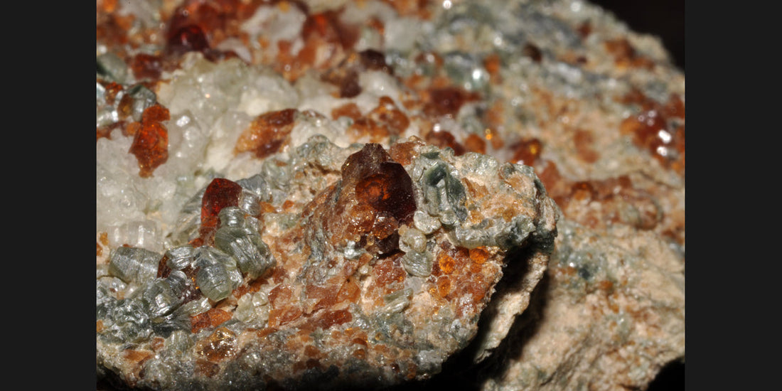 Hessonite garnet crystals with clinochlore from Italy; photo by Géry Parent, public domain — Roosters Peacock crystal guide