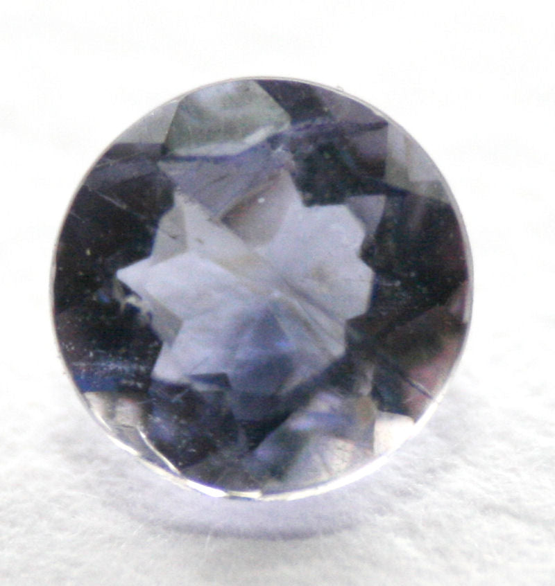 Natural iolite gemstone (gem-quality cordierite); photograph by Humanfeather / Michelle Jo, CC BY 3.0 — Roosters Peacock crystal guide