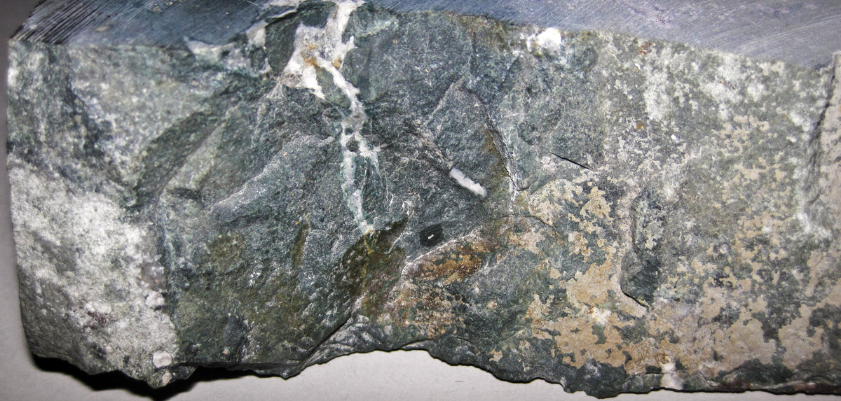 Natural nephrite jade specimen from Oregon, USA; photograph by James St. John, CC BY 2.0 — representative jade specimen for Roosters Peacock crystal guide