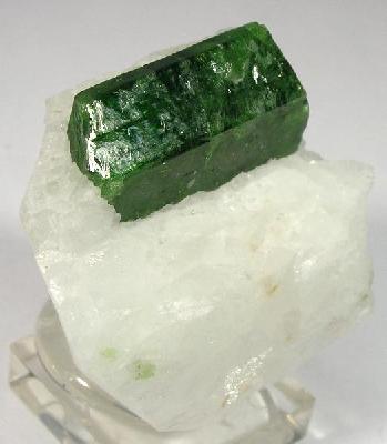 Natural deep-green pargasite crystal on marble from Ganesh, Hunza Valley, Pakistan; Rob Lavinsky, CC BY-SA 3.0 — Roosters Peacock crystal guide