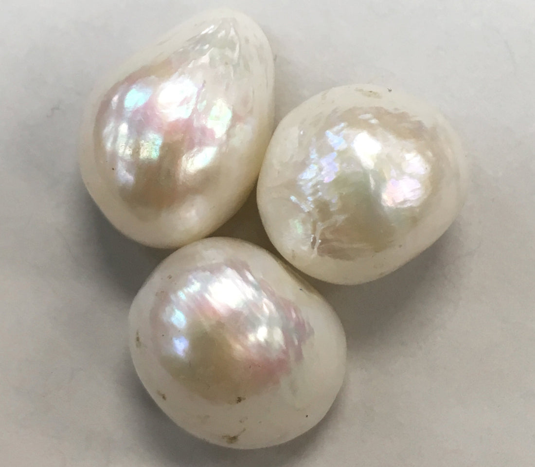 Natural pearls showing nacreous aragonite; photograph by Tyler Houck — Roosters Peacock crystal guide