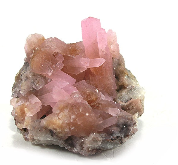 Natural pink manganoan calcite from near Schneeberg, Germany; Rob Lavinsky, iRocks.com, CC BY-SA 3.0 — Roosters Peacock crystal guide