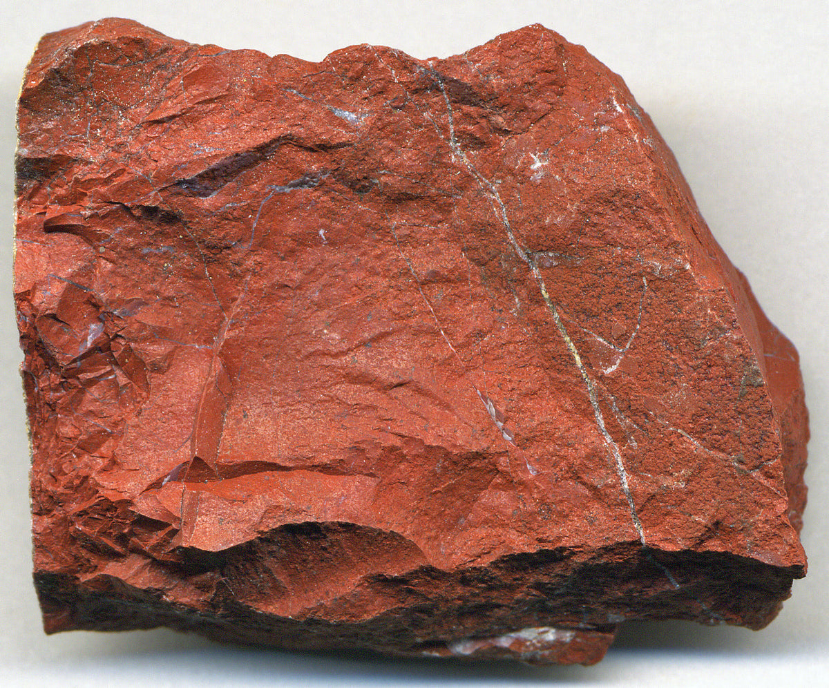 Natural red jasper, an opaque iron-rich microcrystalline silica material; James St. John, CC BY 2.0 — Roosters Peacock crystal guide
