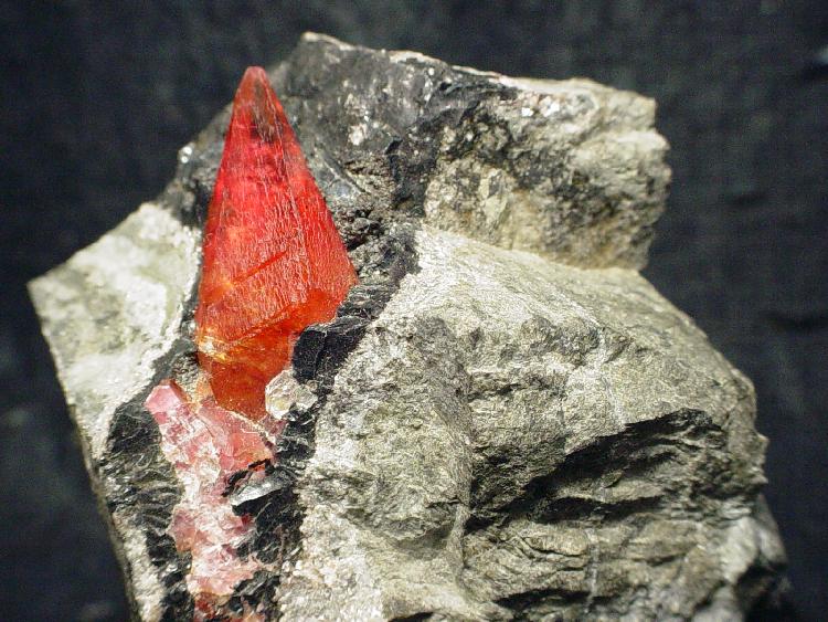 Natural cherry-red rhodochrosite crystal from Uchucchacua Mine, Peru; Rob Lavinsky, CC BY-SA 3.0 — Roosters Peacock crystal guide