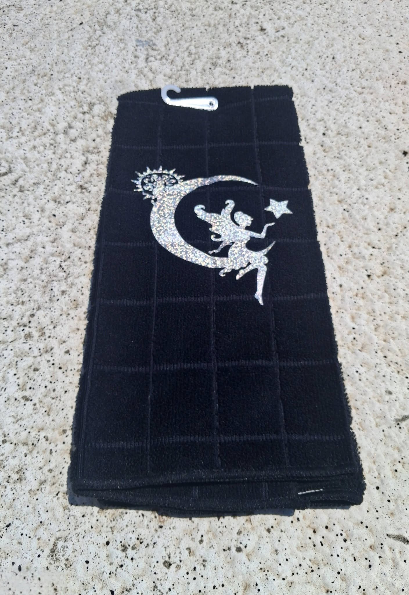 Black microfiber fairy moon towel close up showing silver glitter fairy crescent moon and star design