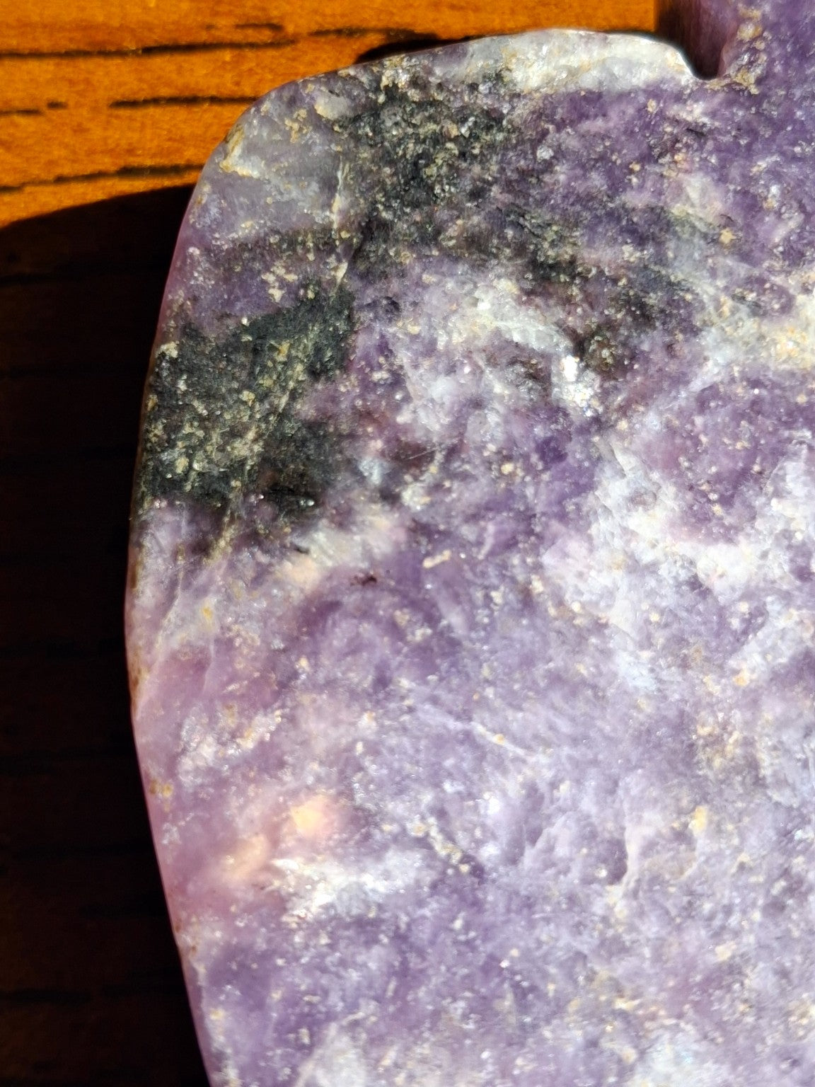 Macro image of amethyst pumpkin carving natural purple mineral variation and dark speckles