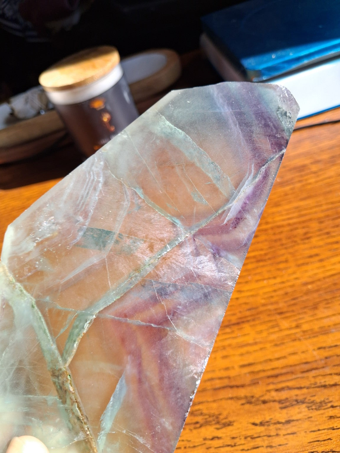 Close-up of Rainbow Fluorite slab multicolor mineral bands pale green blue and violet under natural light