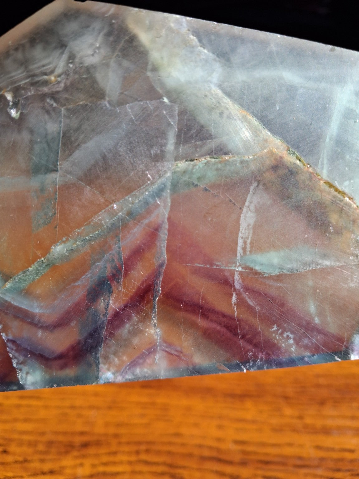 Polished Rainbow Fluorite mineral slice detail lavender purple banding and natural layered planes