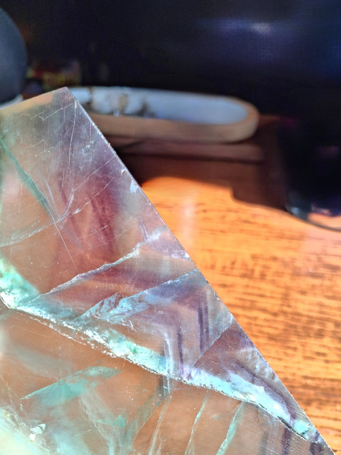 Detailed close shot of green purple Rainbow Fluorite mineral slab banding and internal intersections