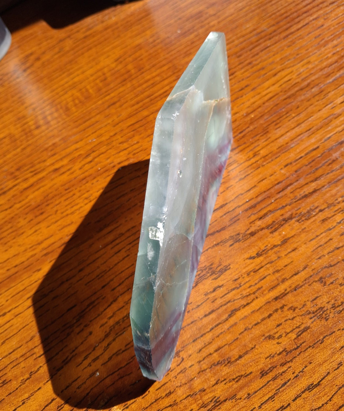 Oblique side view of 6.74 ounce green purple Rainbow Fluorite thin slab