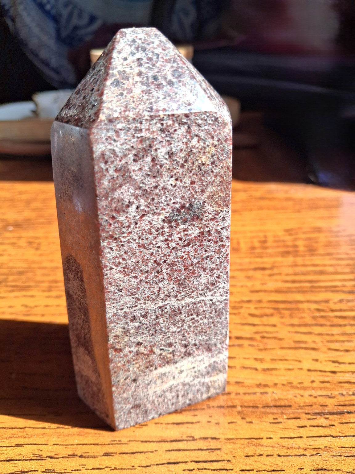 Natural 4.5 inch garnet-in-matrix polished point tower, rich red speckled gray white mineral surfaces