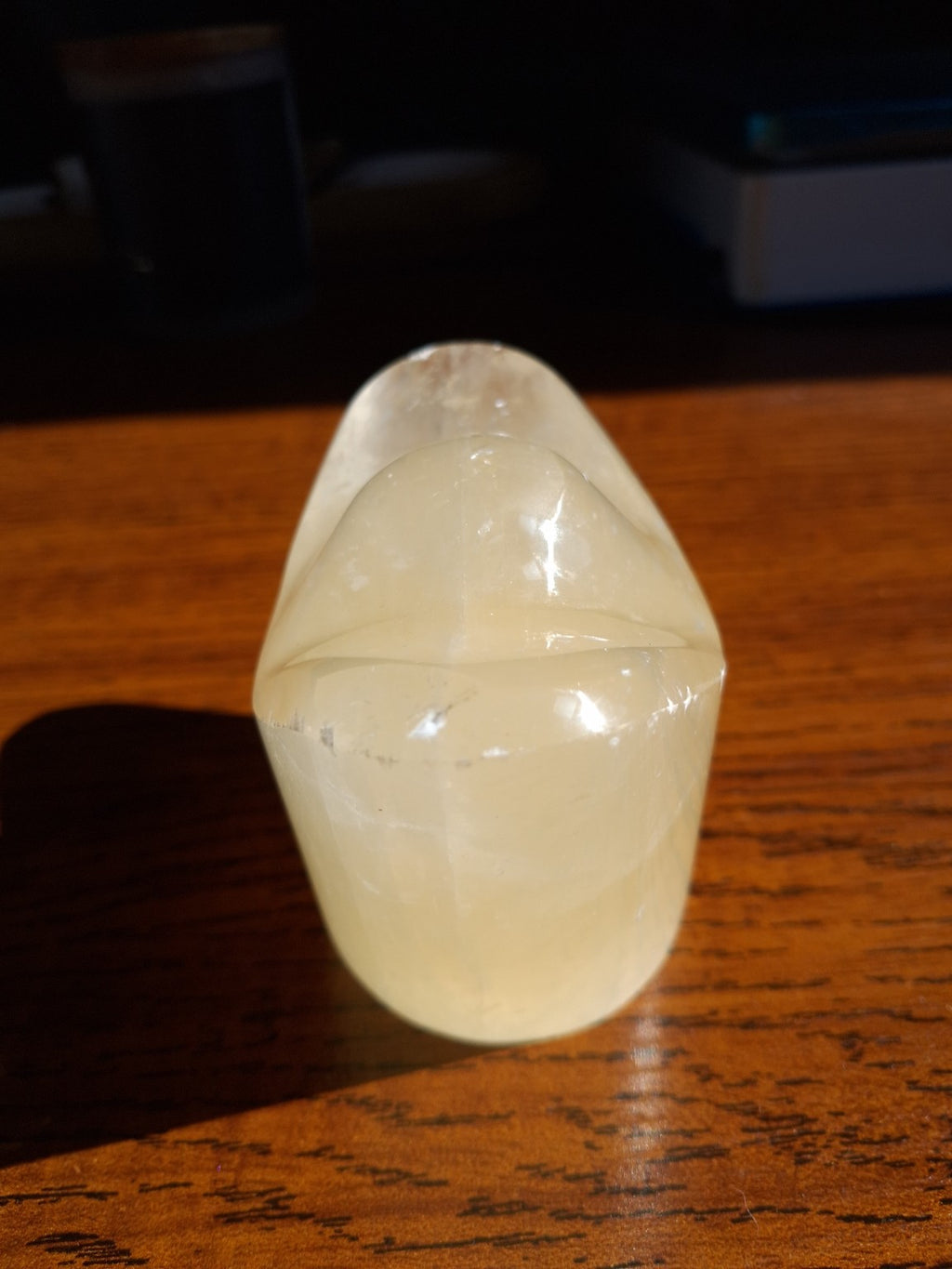 Honey Calcite money ingot narrow end showing smooth polished surface and natural patterns