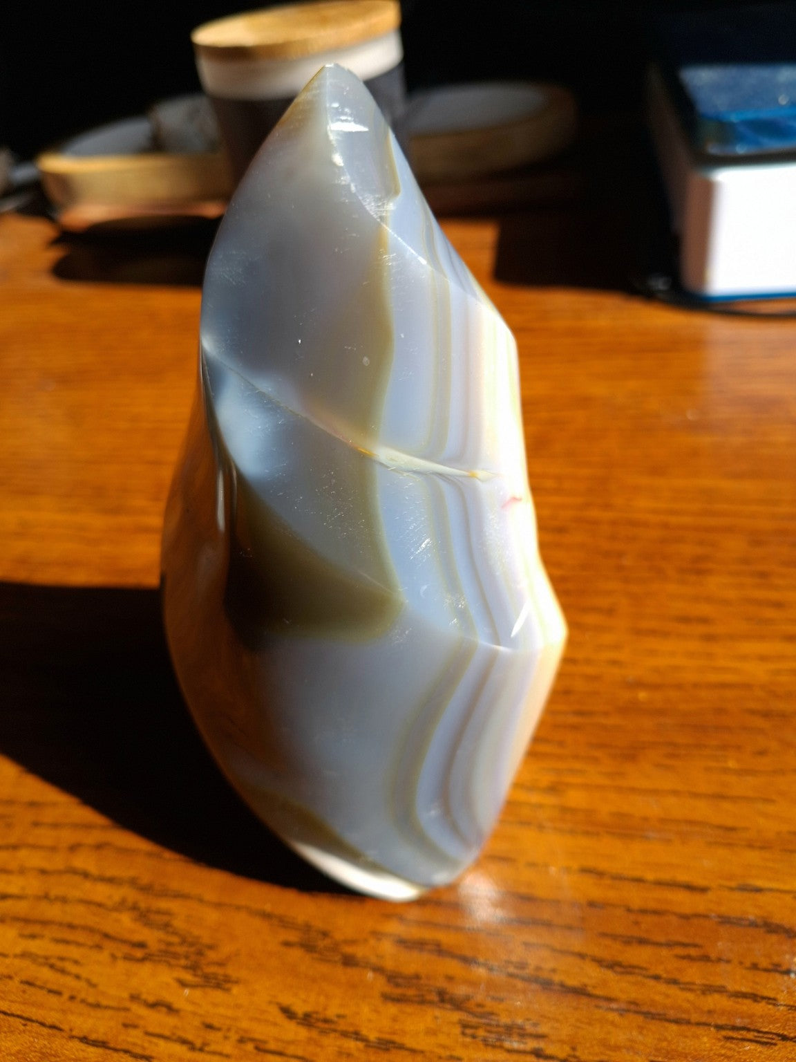 Orca Agate natural polished flame second angle showing layered cream and gray blue chalcedony
