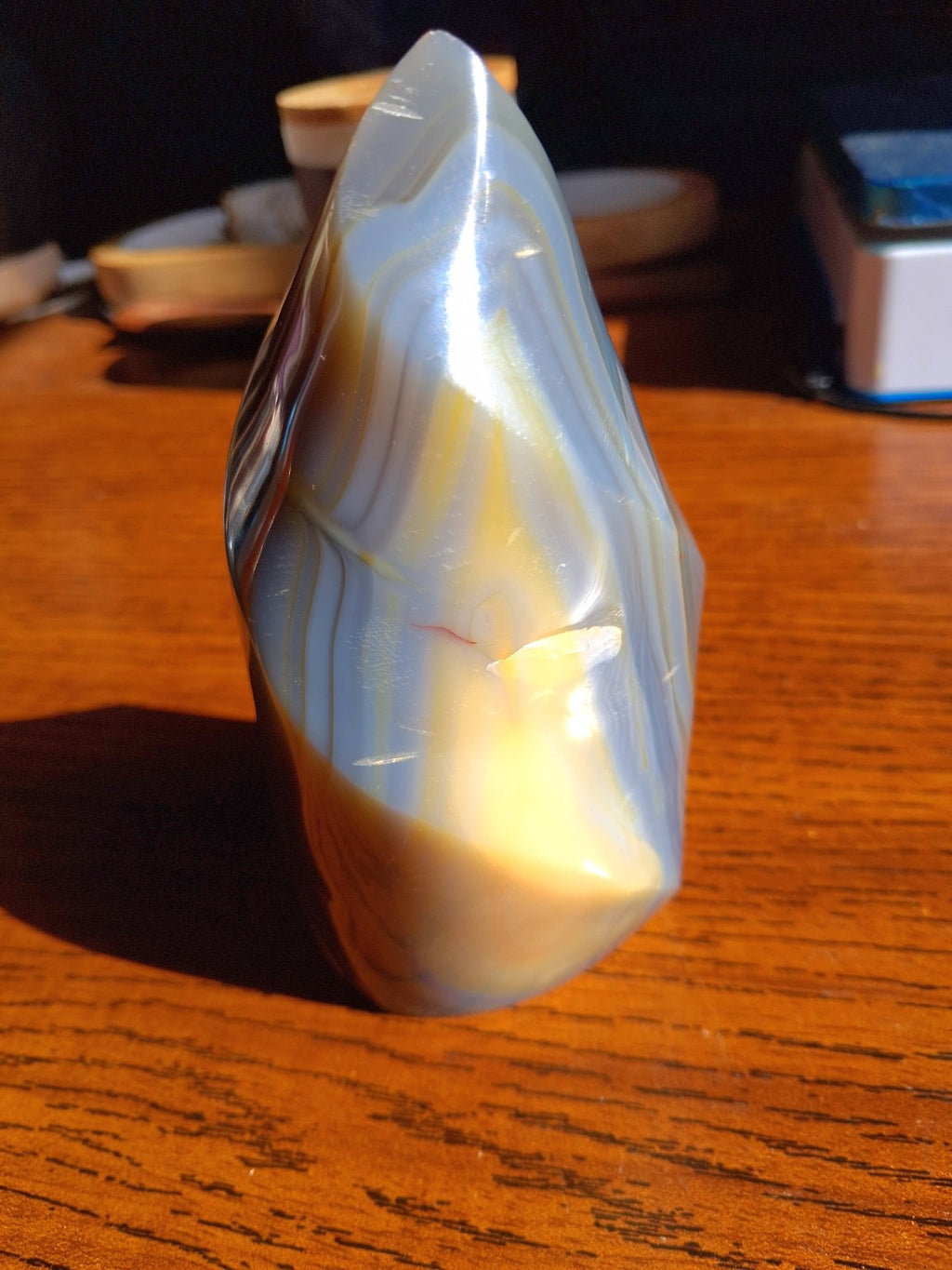 Orca Agate flame third view with translucent-looking gray cream and golden bands
