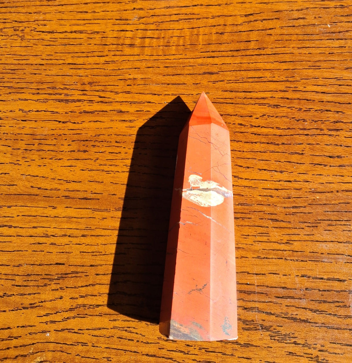 Original full-length view of red jasper tower from above, showing pointed top, slim rectangular facets and cream band